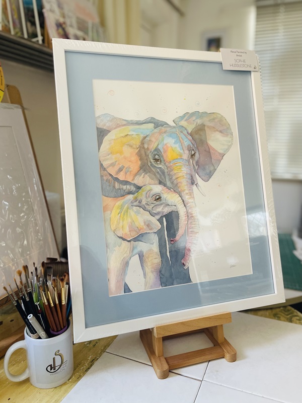 family snuggles elephants a painting by Sophie Huddlestone