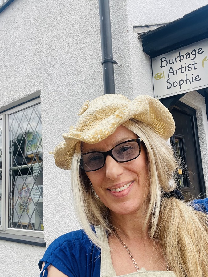 Burbage artist Sophie Huddlestone standing next to her art studio