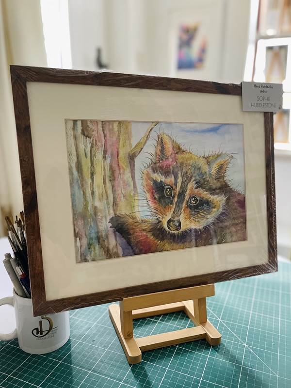 watercolour painting of a raccoon, by Burbage artist Sophie Huddlestone